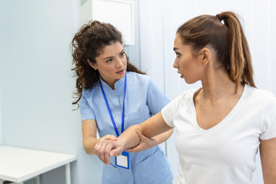 doctor teaching young woman to do osteoporosis treatment exercise in modern clinic. Physiotherapist helping female patient during muscle rehabilitation physiotherapy