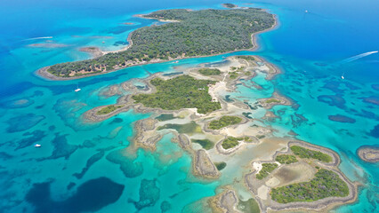 Fototapeta na wymiar Aerial drone photo of tropical exotic volcanic island complex of Lihadonisia forming a blue lagoon and small islet of Monolia with turquoise clear organised beach, north Evia island, Greece