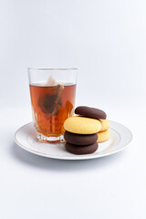 Hot tea and delicious brownies ready to eat on a white background