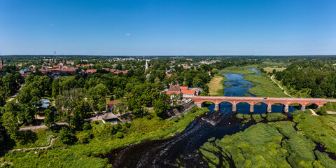 Aerial view of an old brick bridge across the Venta river in Kuldiga, Latvia.