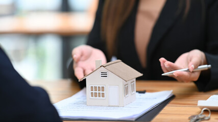 Cropped view of real estate agent offering home ownership and property insurance to costumer