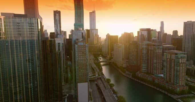 Unbelievable scenery of amazing metropolis at sunset. Beautiful Chicago skyscrapers at the backdrop of orange sky.