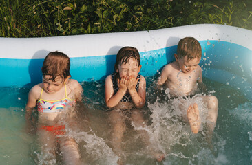 Cheerful happy children in swimming pool. Summer time