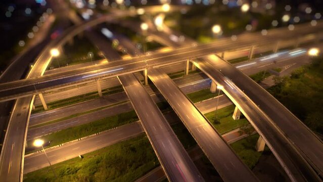 Aerial view from a drone flying over interchange and multi junction road. transportation concept. night traffic time lapse. hyperlapse. Bangkok, Thailand

