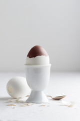 Chocolate egg on white eggstand holder