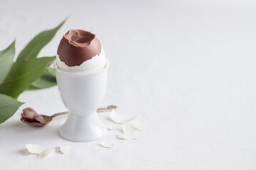 Chocolate egg on white eggstand holder