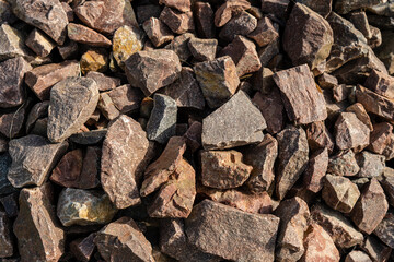 Brown rubble texture. Gravel pebbles stone background. Brown small rocks ground.