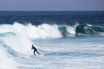PUERTO DE SANTIAGO, TENERIFE - JUNE 2022: surfer riding the waves in Tenerife