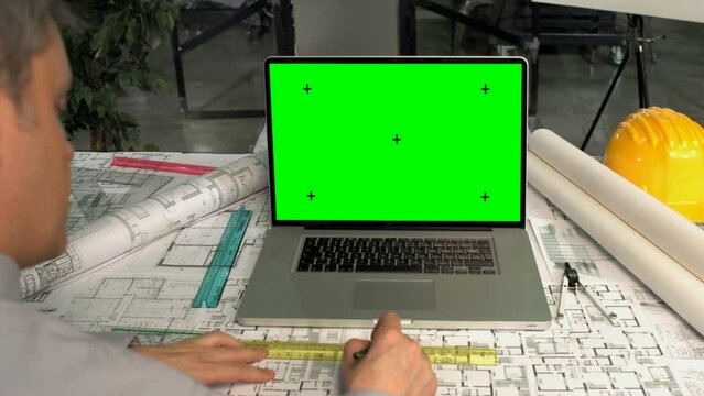 working on computer with green screen