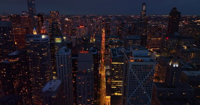Wonderful skyline picture of impressive Chicago at night time. Light streets among beautiful skyscrapers from aerial perspective.