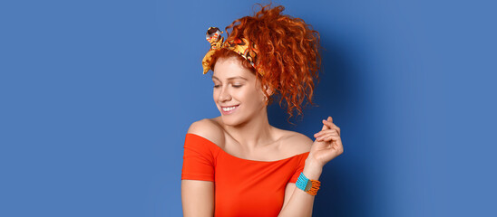 Beautiful redhead woman on blue background