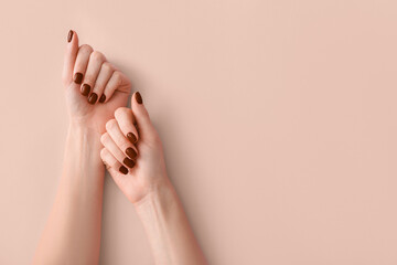 Female hands with beautiful brown manicure on light background - obrazy, fototapety, plakaty