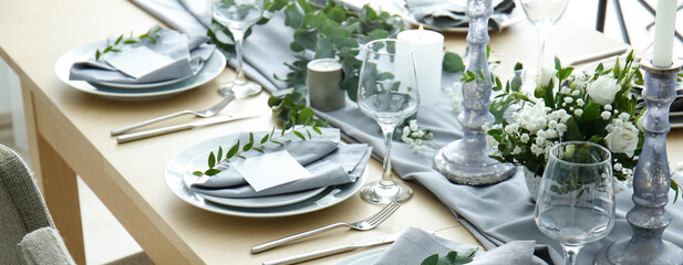 Beautiful festive table setting with floral decor and candles