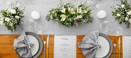 Beautiful wedding table setting with floral decor and candles