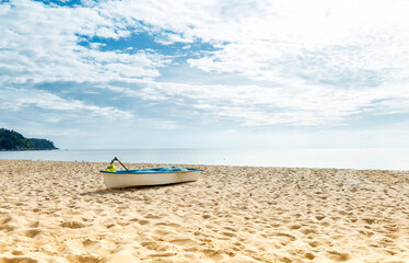 Fototapeta na wymiar Fishing boat on sany beach, tropical summer concept background