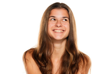 Portrait of young female adult with long hair smiling, isolated on white.