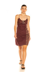 Young woman in summer dress posing in studio, isolated on white background.