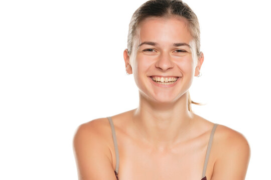 Portrait of smiling young woman without make up, isolated on white background.