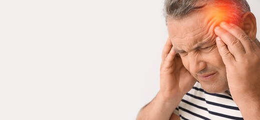 Fototapeta premium Mature man suffering from headache on white background with space for text