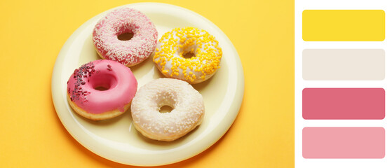 Plate with sweet donuts on yellow background. Different color patterns