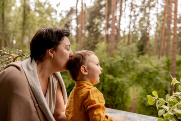 Fototapeta premium Happy grandmother and grandson enjoy time together. Positive middle age woman spending time with little, cute grandchild, having fun. 50-year-old grandma with grandkid. Multi-generational family.