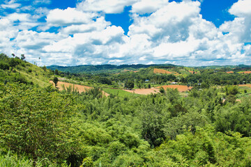 Fototapeta na wymiar The green, fertile hill country with fields and forests of Khao Khao, province of Phetchabun, Central Thailand, a popular holiday destination for people from Bangkok.