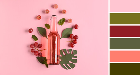 Bottle of fresh soda with grapes on pink background. Different color patterns