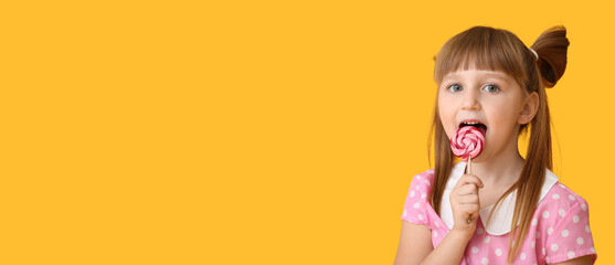 Cute little girl with lollipop on orange background with space for text