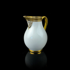white antique milk jug with gold pattern. retro vessel for milk. coffee service. vintage gravy boat
