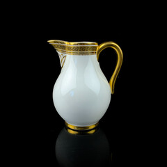 white antique milk jug with gold pattern. retro vessel for milk. coffee service. vintage gravy boat