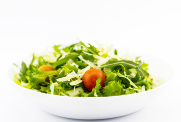 Plate with fresh green lettuce and tomatoes.