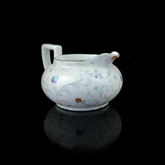 antique milk jug with floral pattern. retro vessel for milk. coffee service. vintage gravy boat