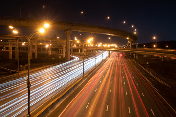 Fototapeta na wymiar Modern highway at night with car light trails. Long exposure shot of road lights
