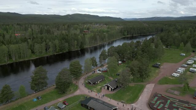 The start of Uka Pain 50 miles trail run. Drone footage forward dolly following the runners along the river.