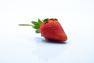 Close up of fresh strawberry fruits with white board as background