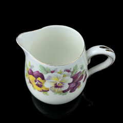 antique milk jug with floral pattern. retro vessel for milk. coffee service. vintage gravy boat
