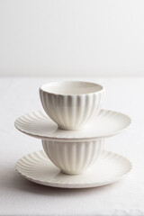 Fototapeta na wymiar Set of white dishes on a white table
