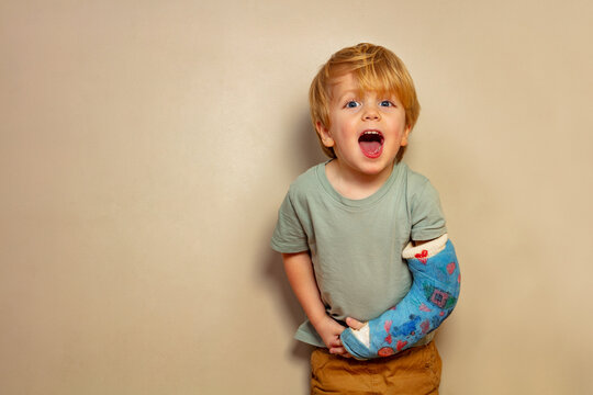 Laughing boy despite broken hand in plaster cast after accident