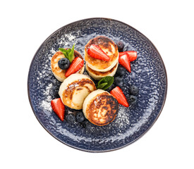 Plate with cottage cheese pancakes, fresh berries and mint leaves on white background