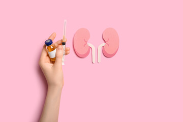 Woman with ampule, syringe and paper kidneys on pink background