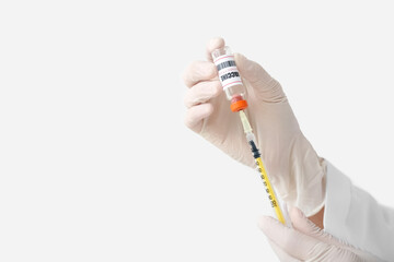 Female doctor with monkeypox vaccine and syringe on light background, closeup