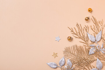 christmas or new year composition. christmas decorations in silver and gold colors on pastel beige background with empty copy space for text. top view