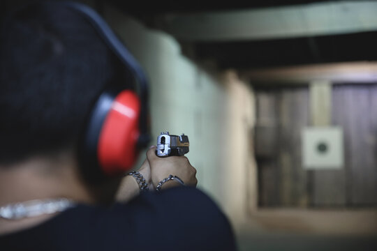 Man Pistol bullseye target training in a shooting club