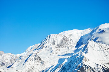 Fototapeta na wymiar Peaks in snow Mont Blanc Alps mountains massif over blue sky