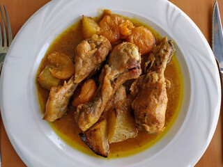 Chicken thighs with potatoes and dried apricots.