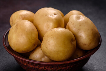 A pile of young potatoes on the table. The benefits of vegetables