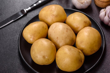 A pile of young potatoes on the table. The benefits of vegetables