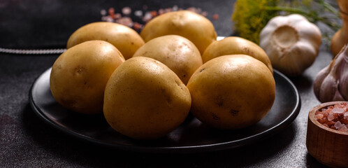 A pile of young potatoes on the table. The benefits of vegetables