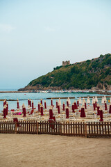 Sun loungers and umbrellas on the beach in Scauri, Italy.