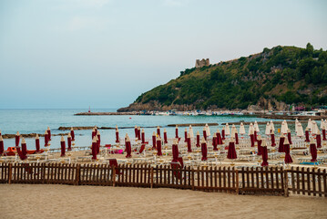 Sun loungers and umbrellas on the beach in Scauri, Italy.
